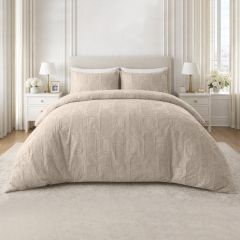 Natural embossed duvet cover set with a textured geometric design and matching pillowcases on a modern bed.