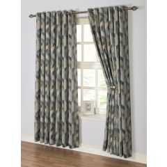 Geometric-patterned curtains in earthy green tones partially open, revealing a window with a small framed picture on the sill, set against a light wall.