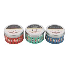 Set of three Nutcracker scented candles in tins with red, green, and blue festive designs
