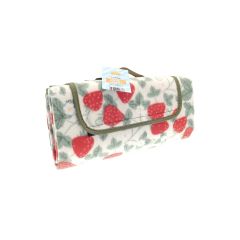 A folded picnic blanket with a red strawberry and green leaf pattern, bound by olive green trim. A tag reads "Large Picnic Blanket." Bright and cheerful.