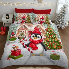 Festive bedding depicts penguins in red hats with a candy cane, gifts, and a gingerbread house. Snowy trees, lights, and a cozy Christmas ambiance.