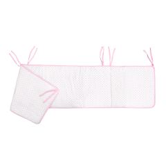 White quilted crib bumper with pink polka dots and pink trim, featuring tie strings for attachment.