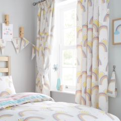 Children's room with pastel blue walls features a window adorned with colorful curtains. Decorated with unicorns, rainbows, and stars, creating a playful, whimsical atmosphere. A pink potted plant sits on the windowsill.