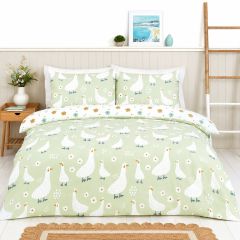 Green duck print duvet cover set with white ducks and daisy flowers in a bright modern bedroom
