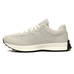 A sleek, minimalist white sneaker with textured details and a black rubber sole. The design is modern and versatile, exuding a casual, stylish vibe.