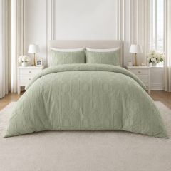 Sage embossed duvet cover set with a textured geometric design and matching pillowcases on a modern bed.