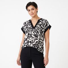 womens black and white abstract print blouse with cap sleeves and black trousers