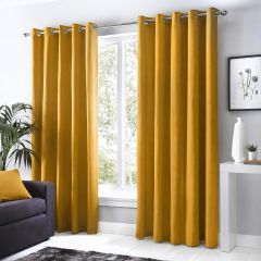 Ochre Sorbonne eyelet curtains framing a window in a bright, modern living room.