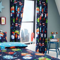 Brightly colored kids' room with space-themed decor. Curtains and bedding feature cartoon planets and aliens. A city skyline is visible outside. Fun, playful vibe.