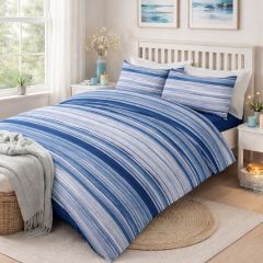 Bedroom with a white wooden bed, blue and white striped bedding, and a large window letting in natural light.