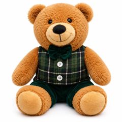 Large brown teddy bear soft toy dressed in a green tartan waistcoat with velvet bow tie and matching trousers, sitting upright on a white background