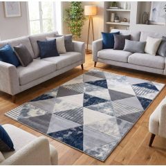 Contemporary rug with a geometric triangle pattern in shades of navy blue, grey, and white, featuring a mix of solid, textured, and striped designs