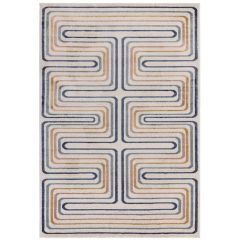 Cream rug with a retro geometric maze pattern in blue, blush pink, mustard, and grey.