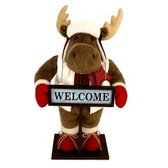Plush Christmas reindeer decoration holding a WELCOME sign, wearing red mittens, scarf, and winter hat.