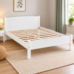 White wooden bed frame with visible wooden slats in a bright modern bedroom.