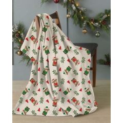 Cozy Christmas throw draped over a chair, decorated with snowmen, trees, and holly, beside glowing garlands for a festive, warm mood.
